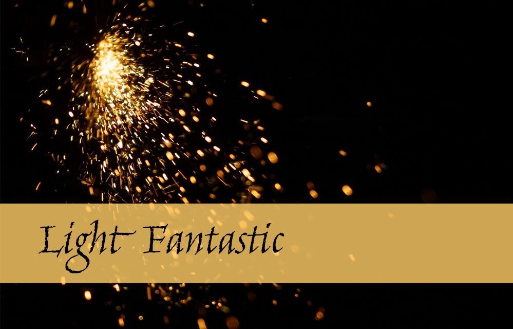 The text 'Light Fantastic' written on a background with lots of sparks.